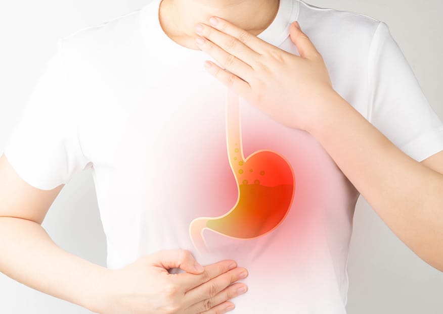 A bottle of apple cider vinegar with a glass of diluted ACV, used as a natural remedy for acid reflux relief.